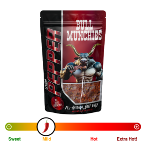 Bull Munchies Lemon Pepper Beef Jerky packaging featuring a muscular bull character holding a piece of jerky. The package highlights ‘No Added Hormones,’ ‘All-Natural Beef Jerky,’ and ‘Net Wt. 2.6 oz (74 g).’ The jerky inside is visible in the lower part of the package.“​